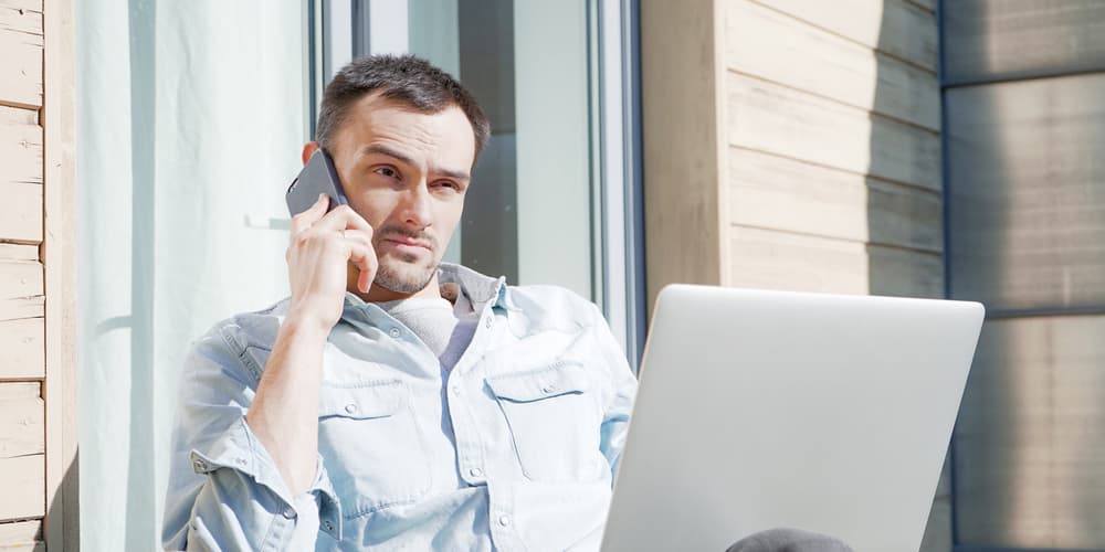 Ein Mann möchte die Grundschuld eintragen und telefoniert mit dem Notar